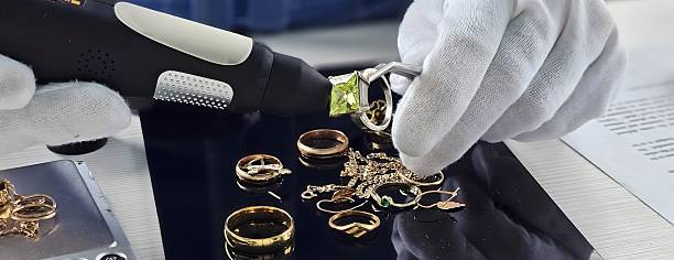 Expert gemologist examines various golden rings